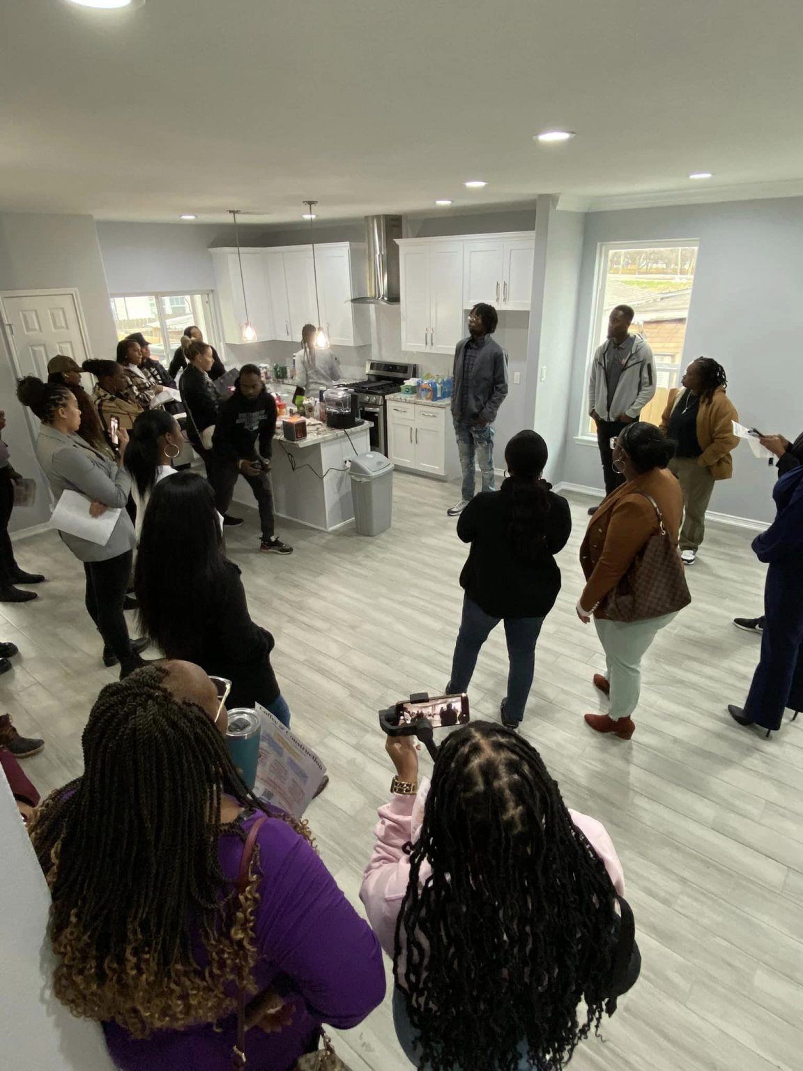 Coffee & Construction guests touring a finished BEDDIEO kitchen